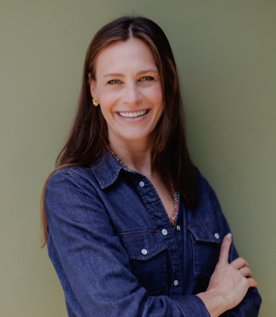 Sarah smiling in a denim shirt